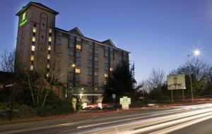 a building with a clock tower next to a street at Holiday Inn Slough Windsor by IHG in Slough