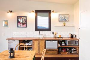 a kitchen with a wooden counter top and a table at The Ridge Eco-Cabins - A Secret Place to Slow Down in Gloucester