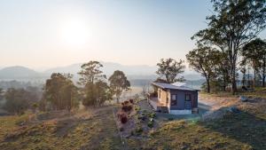 a small house sitting on top of a hill at The Ridge Eco-Cabins - A Secret Place to Slow Down in Gloucester