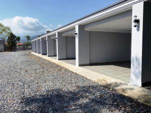 a row of garages on the side of a building at Mean Leap Guesthouse in Kampot