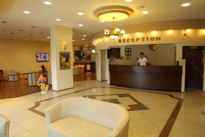 a reception desk in a hospital lobby with a woman at Cihan Hotel in Hopa