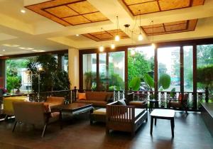 a lobby with couches and tables and large windows at Nana Buri Hotel in Chumphon +14 photos