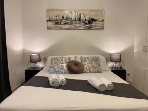 a bedroom with a bed with towels on it at Holiday Home Darko in Novalja