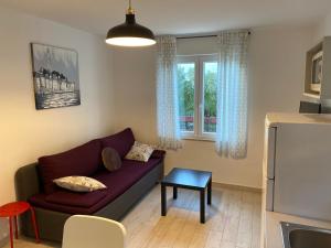 a living room with a couch and a window at Holiday Home Darko in Novalja