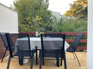 a table with two chairs and a tablecloth on it at Holiday Home Darko in Novalja