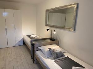a small room with two beds and a mirror at Holiday Home Darko in Novalja