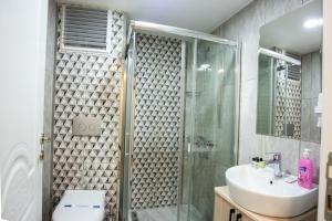 a bathroom with a glass shower and a sink at Royal Bosphorus Hotel & SPA Hamam in Istanbul