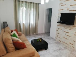 a living room with a couch and a flat screen tv at Apartment Iv in Kotor