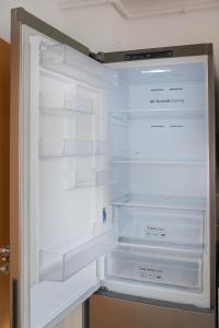 an empty refrigerator with its door open at Barko Residence 1 in Braşov