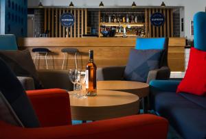 a bottle of wine sitting on a table in a restaurant at Holiday Inn Express Portsmouth – North by IHG in Portsmouth