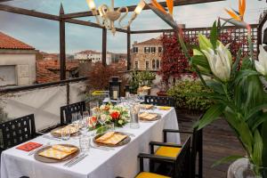 a table on the roof of a building with food on it at Ca' Pisani Hotel in Venice