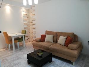 a living room with a couch and a table at Apartment Iv in Kotor