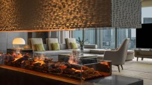 a living room with a fireplace and a couch at InterContinental Tianjin Yujiapu Hotel & Residences, an IHG Hotel in Binhai