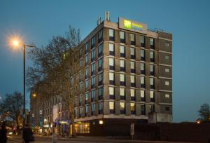a tall building with a sign on the top of it at Holiday Inn Express Bristol City Centre, an IHG Hotel in Bristol