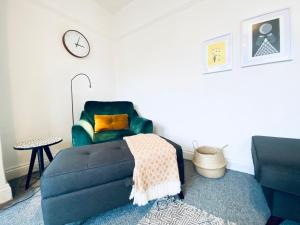 a living room with a couch and a chair at Hill Cottage in Haworth