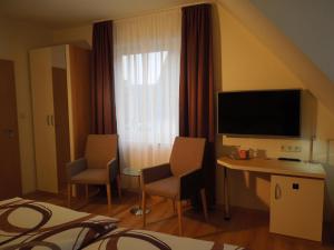 TV a/nebo společenská místnost v ubytování Hotel Gode Wind