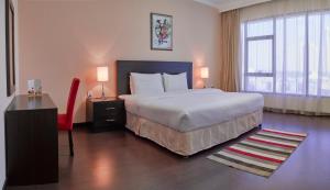 سرير أو أسرّة في غرفة في Tulip Hotel & Suites