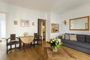 a living room with a couch and a table at Mithouard Apartments in Paris