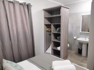a bathroom with a shower and a toilet and a sink at Rosedene in Bloemfontein