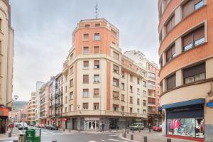 a tall brick building on a city street at MODERN LOVELY HOUSE GUGGENHEIM in Bilbao