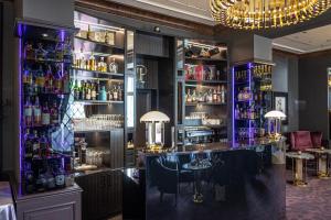 a bar with purple lighting in a restaurant at Le Palais Art Hotel Prague in Prague