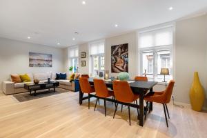 a dining room and living room with a table and chairs at Keyser Apartments 6 in Bergen +50 photos