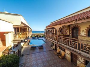 a view of a building with a pool and the ocean at Jimmy Hotel in Dahab