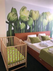 a bedroom with a mural of flowers on the wall at Hotel SOREA TRIGAN in Vysoke Tatry - Strbske Pleso