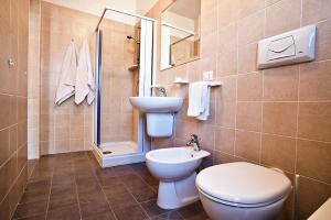 a bathroom with a toilet and a sink and a shower at Felicity Vieste in Vieste