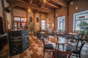 a restaurant with tables and chairs in a room at TeleDom Hotel in Košice
