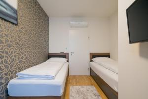 Łóżko lub łóżka w pokoju w obiekcie MyApartments Vienna