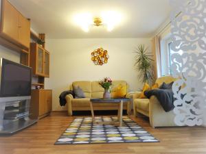 a living room with two couches and a tv at Ferienwohnungen Koller in Bodenmais