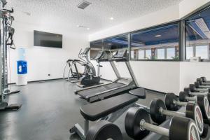 a gym with treadmills and cardio machines at Best Western Plus Plaza Hotel Darmstadt in Darmstadt