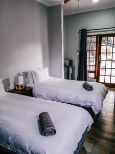 A bed or beds in a room at The Bosau Guest House