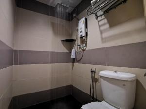 a bathroom with a toilet and a shower at Star Bay Hotel in Lumut