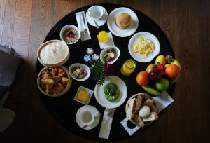 a black plate of food with breakfast foods on it at CoolRooms Palacio Villapanés in Seville