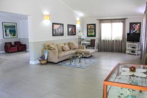 a living room with a couch and a table at Albaruja Hotel in Costa Rei