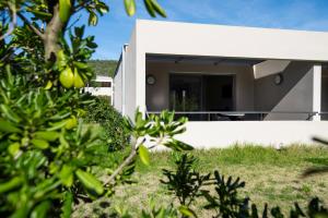 a house with a view of the backyard at Costa Nera Beach House in Porto-Vecchio