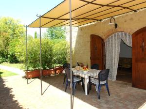 einen Tisch und Stühle unter einem Sonnenschirm auf einer Terrasse in der Unterkunft Holiday Home Capanna di Sopra by Interhome in Villa Bertolli