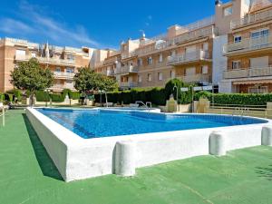 a swimming pool in front of a building at Apartment Aires de mar by Interhome in Cunit