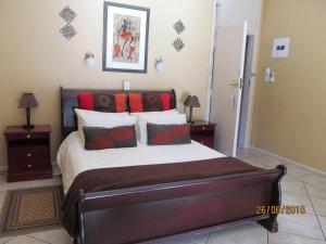 a bedroom with a large bed with red pillows at Old Post Office Lodge in Wilderness