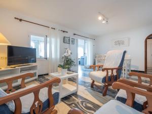 a living room with a flat screen tv and chairs at Apartment Voramar by Interhome in Alcudia