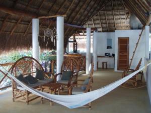 a hammock in the middle of a room at Casa Pascale in Punta Allen