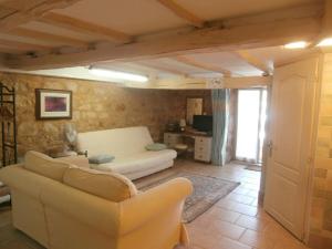 a living room with a white couch in a room at The Studio in Hautefort