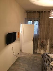 a room with a door and a television on the wall at Affittacamere Real Fly in Bologna