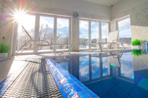 a swimming pool with a pool house with a swimming poolvisorvisor at Dwór i Dworek Leszczowate Wellness & Spa in Ustrzyki Dolne