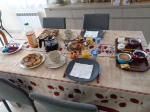 a table with breakfast foods and drinks on it at Gîte Nelly in Meschers-sur-Gironde