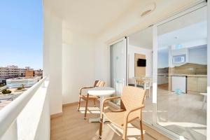 a apartment with a balcony with a table and chairs at Sun Beach in Santa Ponsa