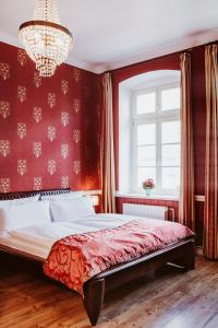 a bedroom with a large bed and a large window at Garden Boutique Hotel in Berlin