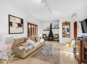 a living room with a couch and a fireplace at Villa Can Moya in Palma de Mallorca